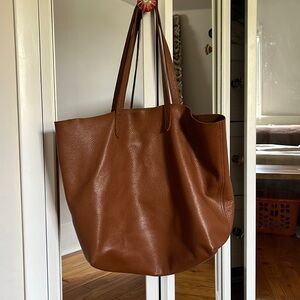 Tan leather Cuyana tote with duster bag